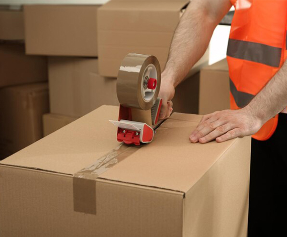 Sealing a cardboard box with tape